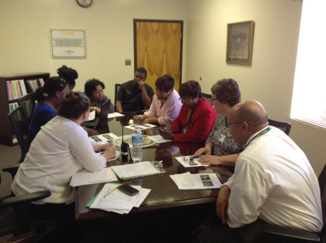 MEMBERS OF THE African American committee meet to discuss plans for the school's annual assembly.