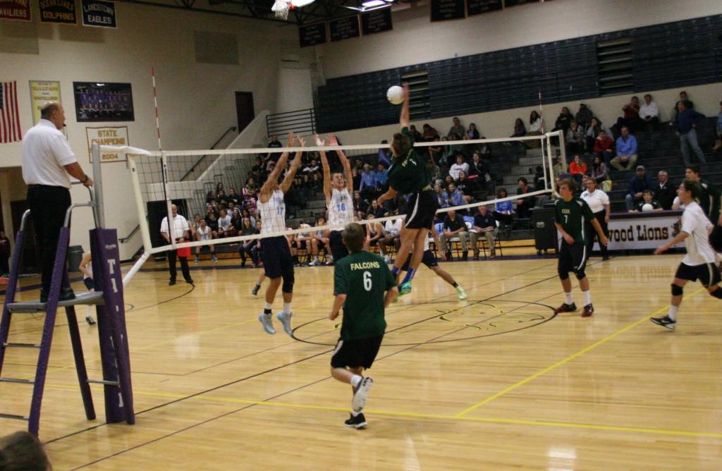 VOLLEYBALL PLAYERS SPIKE the ball against opponent, First Colonial High School.