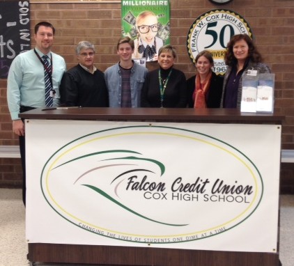 TEACHERS TRAVIS ELLIOTT and Mark Girard officially open the Falcon Credit Union with Mac Pugliese, Assistant Principal Chris Colden, and Principal Dr. Randi Riesbeck.