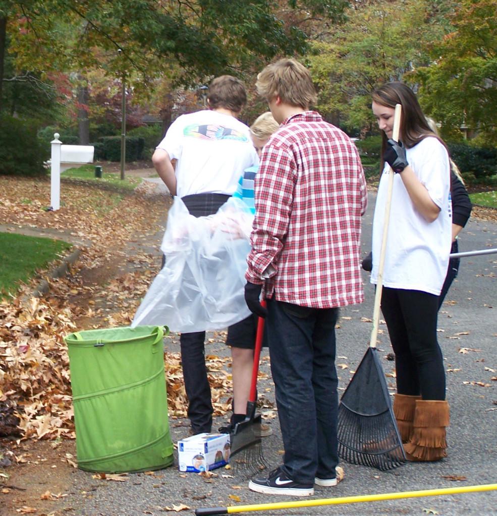 OPERATION SMILE PRESIDENT senior Maggie Smith takes a break from the rake.