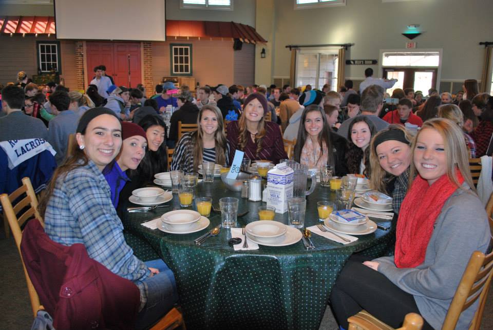 COX YOUNGLIFE LEADER Carly Kelsick sits at the breakfast table with (L-R) Bryanna Ruff (12), Caroline Moorfield (11), Lauren Shirley (10), Addie Kier (12), Katie Harrell (11), Kayla Hooper (11), Katie Daugherty (11) and Courtney Daniels (11) during their weekend retreat to Rockbridge Camp. 