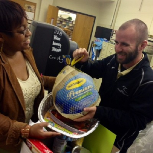 OFFICE MANAGER WENDY Matthis and Athletic Trainer Brian Wright put the finishing touches on a Thanksgiving basket.