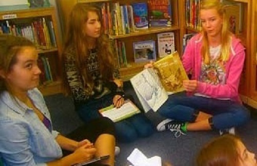 BOOK CLUB MEMBERS read to John. B. Dey Elementary students.