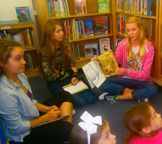 (L-R) BOOK CLUB MEMBERS Casey Smith(10), Annelise Dietz (9), and Ella Geissinger (11) recently took a field trip to read to John B. Dey Elementary students.