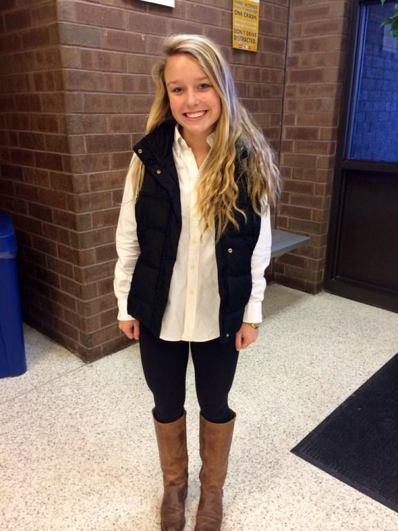 SOPHOMORE ALEX BREWER rocks her white puffer vest with black leggings and tall brown boots.
