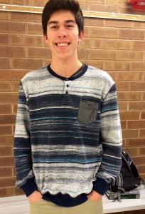 JUNIOR BRETT ROSENMEIER smiles while wearing his trendy striped sweater with neutral colored pants.