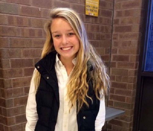 SOPHOMORE ALEX BREWER rocks her white puffer vest with black leggings and tall brown boots.