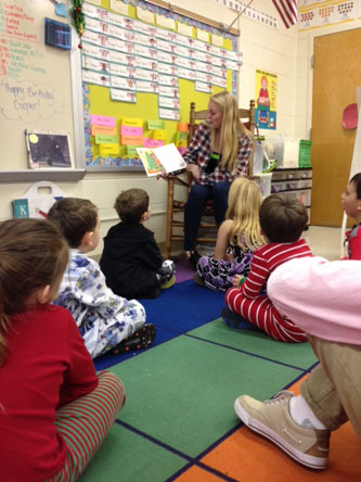 SCA MEMBER SOPHOMORE Riley Weers reads to elementary students at John B. Dey.