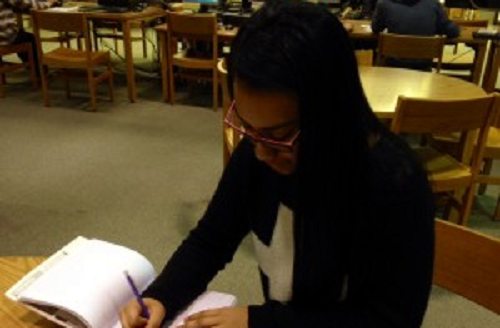 JUNIOR ANGELINA GARZA prepares for an upcoming test in the library.