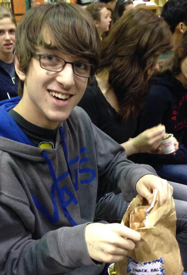 FRESHMAN JONAH HOWELLS enjoys his snack bag, provided to all students by Trader Joes.