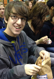 FRESHMAN JONAH HOWELLS enjoys his snack bag, provided to all students by Trader Joe's.