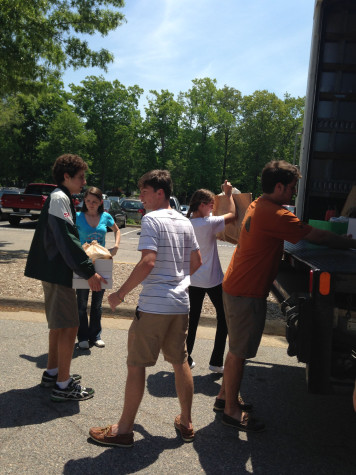 KEY CLUB MEMBERS load boxes for the Samaritan House, along with Two Men & a Truck.