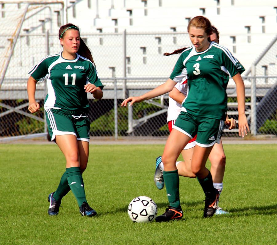 JV GIRLS SOCCER players Olivia Merklinger (9) and Sydney Kier (10) maneuver the ball down the field.