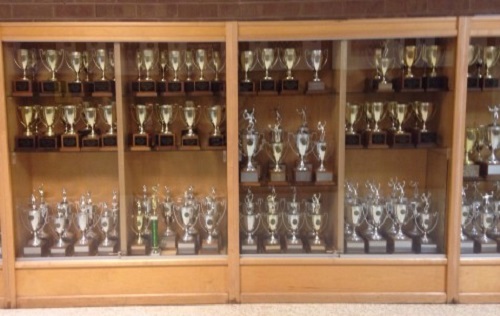 NEW TROPHY CASES  filled with past awards and achievements.