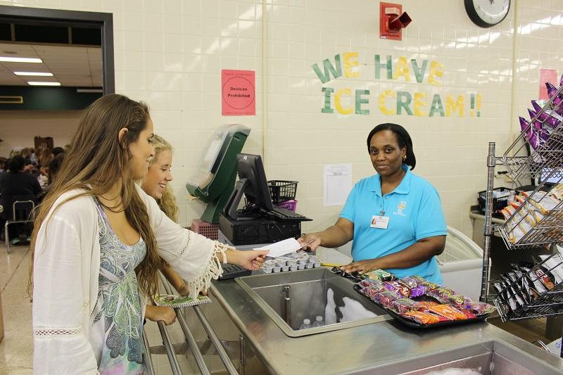 REPORTERS CAROLINE DAVIS and Lauren Harris question Cafeteria Manager Tameka Stull to determine what changes have been made to the schools lunch menu.