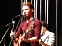 SINGER/SONGWRITER TAYLOR Mathews performs his latest hits for studets at a school assembly.
