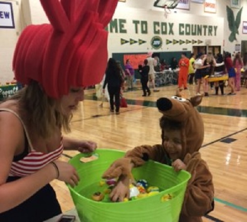 JUNIOR STEPHANIE SNYDER lets Scooby Doo pick some treats from her candy basket.