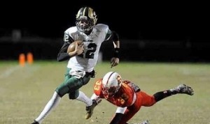 JUNIOR QUARTERBACK COLE Johnson outruns a Bayside Marlin in the Varsity Football teams first ever playoff win.