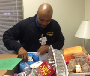 SCHOOL SECURITY GUARD Tony Class compiles Thanksgiving baskets for families within the community.