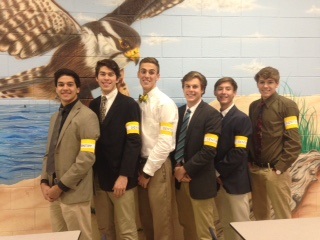 BOYS VOLLEYBALL PLAYERS wear yellow arm bands in remembrance of Gentry.