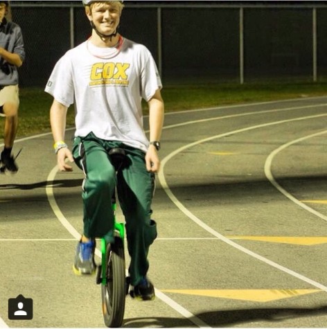 SOPHOMORE AUSTIN JENNINGS cycles around the track during the homecoming parade.