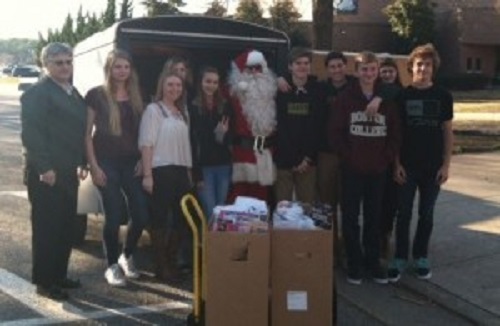 NOBEL TEENS SPONSOR Mark Girard and service club members collect Toys-4-Tots.