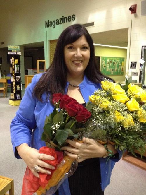 TEACHER OF THE YEAR Deb Erskine accepts flowers after receiving her award.
