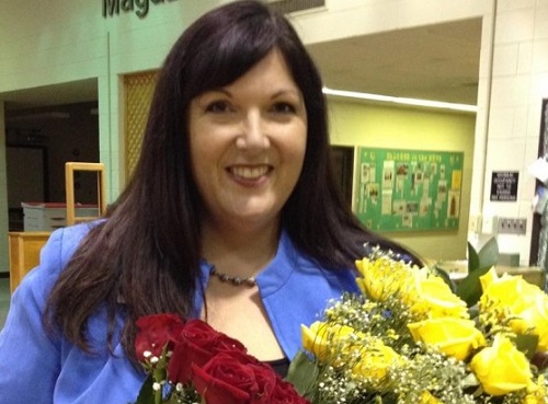 TEACHER OF THE Year Deb Erskine accepts flowers after receiving her award.