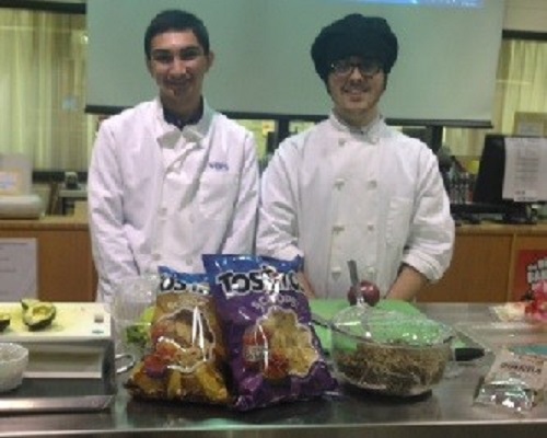 CATERING STUDENTS DEMONSTRATE the art of making Quinoa salad.