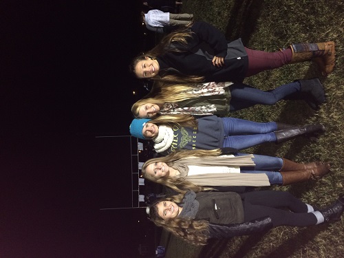 SENIORS reminisce about past bonfires as they attend their final Homecoming week festivities. 