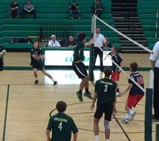 BOYS VOLLEYBALL TEAMMATES set the ball to win a Falcon point.