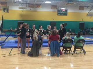 SIX GYMNAST MEET with the judges before they compete on the balance beam.