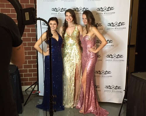 SENIOR MODELS MADISON Dominick, Lauren McGovern, and Haley Henahan pose for a photo after coming off stage. 