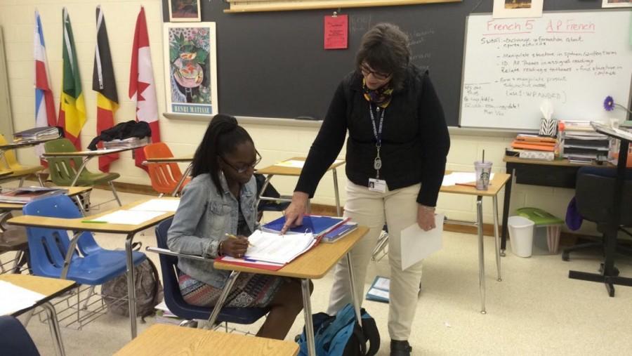 FRENCH HONOR SOCIETY sponsor Madam Beckner works with a member of the honor society.