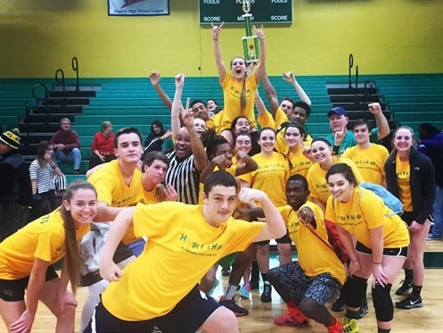 THE WINNING STUDENT team poses with their trophy after the victory over the teacher team.