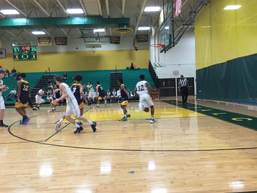 THE BOYS BASKETBALL team work hard to keep possession of the ball.