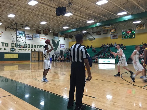 TAVEON ROBINSON PASSES the ball to Senior Greg Hahn for a three-pointer.