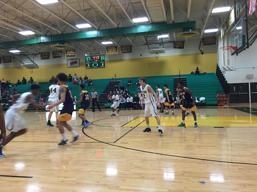 FALCON BASKETBALL STEPS up to defense against Ocean Lakes.