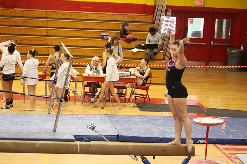 JUNIOR JACKIE GARRET begins her warm up on the beams. 