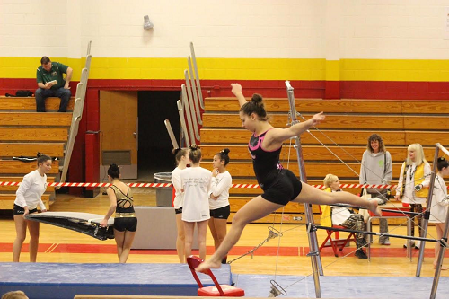 JUNIOR MARY MUNITZ leaps during her warm up. 