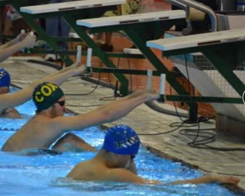 SENIOR COLIN DEMERS takes the position to start his backstroke.