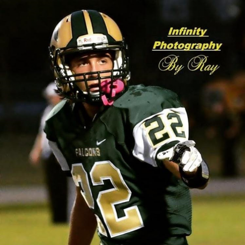 SENIOR JAKE HERSLOW has his picture taken by infinity photography during a game
