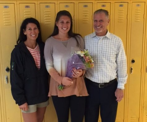 SENIOR BROOKE MOORE stands excitedly between her parents after receiving the coveted VTfT teaching award.