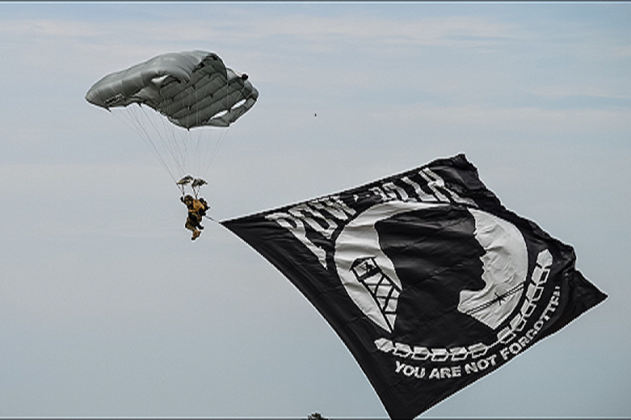 US+NAVY+PARATROOPERS+show+tribute+by+flying+the+POW%2FMIA+flag.++