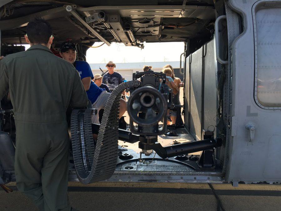 A PILOT EXPLAINS how the on-board machine gun works.