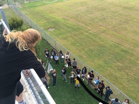 MRS. RHEA'S EARTH Science students wait at the bottom of the stadium to see if the eggs will break.