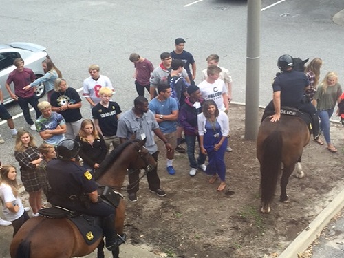 STUDENTS AND TEACHERS  walked outside to chat with the police officers and their horses on Friday morning.