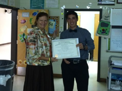PRINCIPAL DR. RIESBECK honored junior Merrick Gessler with the Award of Excellence from the Congress of Future Medical Leaders.