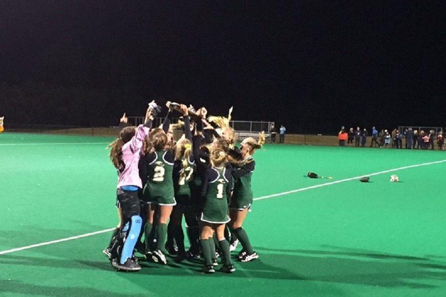 VARSITY FIELD HOCKEY huddles up to cheer after their state title win against First Colonial.