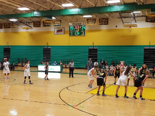 THE JV GIRLS basketball team in the midst of a close game with Kellam on Thursday, December 8.